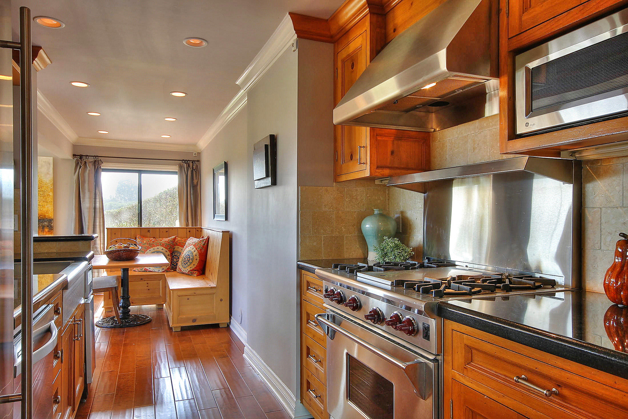 3375 Foothill Road, Unit 1114 AND 1113 Carpinteria, CA 93013 - Photo 6 of 27 a kitchen with stainless steel appliances granite countertop a stove and a refrigerator