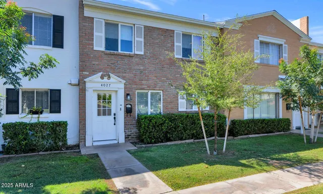 a view of house with a yard and front view of a house