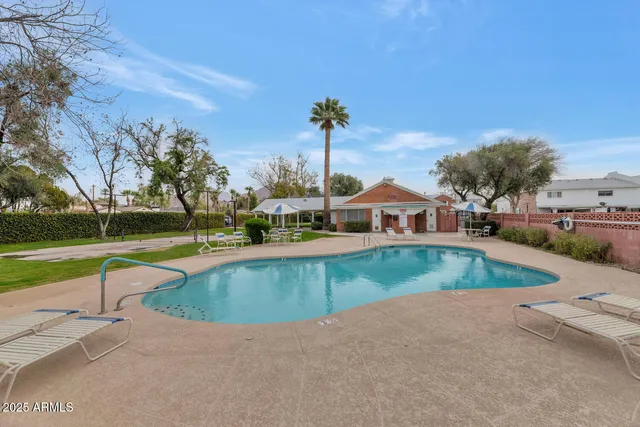 a view of a swimming pool with a yard