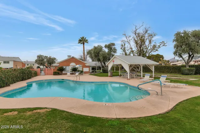 an aerial view of a house with swimming pool patio and lake view