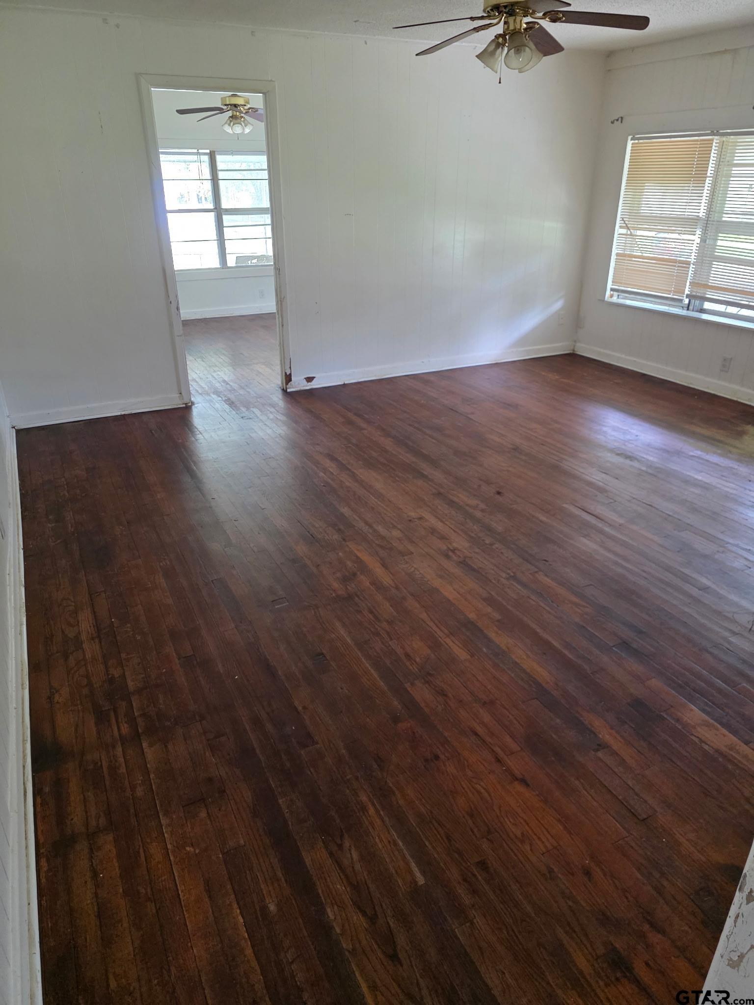 312 5th Street Southwest Bogata, TX 75417 - Photo 4 of 9 wooden floor in an empty room with a window