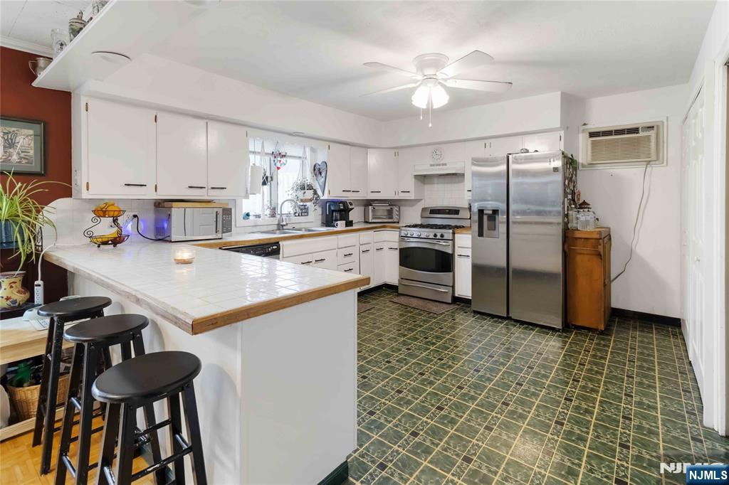 175 Highland Lakes Road Vernon, NJ 07422 - Photo 15 of 50 a kitchen with kitchen island a counter top space appliances and cabinets