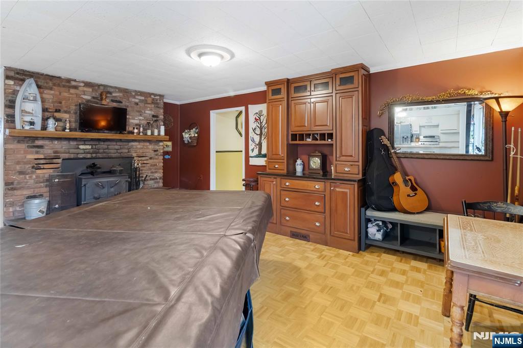 175 Highland Lakes Road Vernon, NJ 07422 - Photo 18 of 50 a bed room with furniture and a flat screen tv