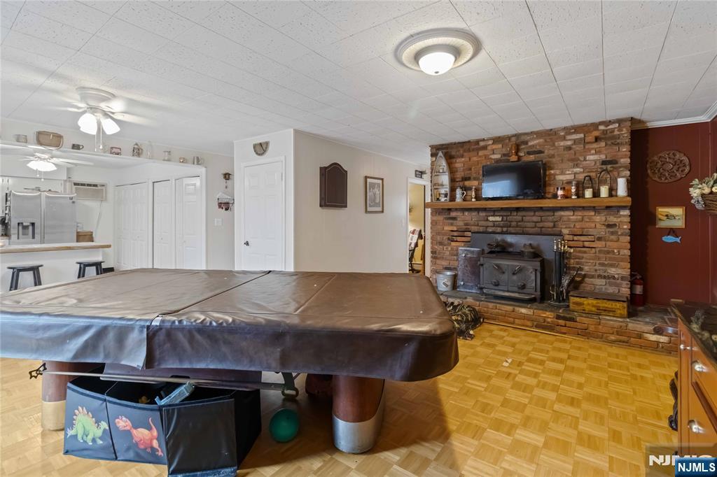 175 Highland Lakes Road Vernon, NJ 07422 - Photo 19 of 50 a living room with stainless steel appliances furniture a fireplace and a flat screen tv