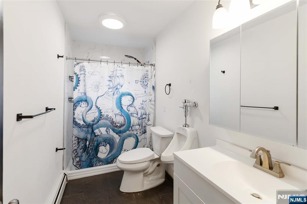 175 Highland Lakes Road Vernon, NJ 07422 - Photo 22 of 50 a white toilet sitting next to a bathroom sink