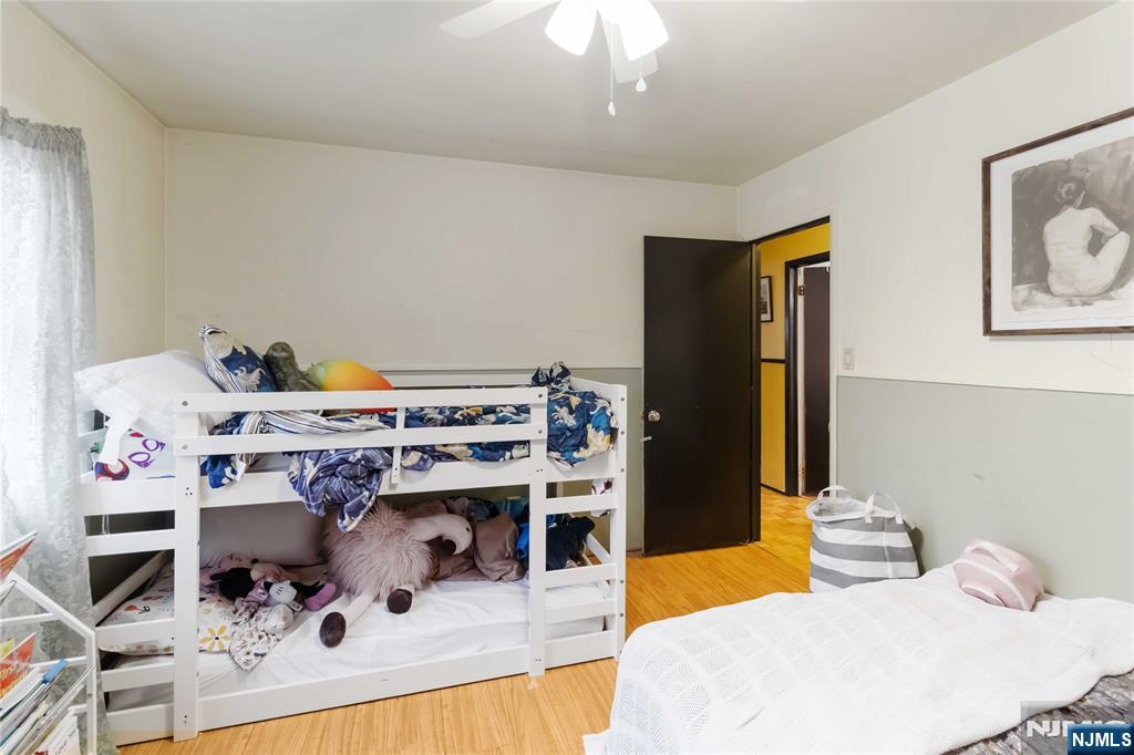 175 Highland Lakes Road Vernon, NJ 07422 - Photo 23 of 50 a bedroom with a bed and a chandelier