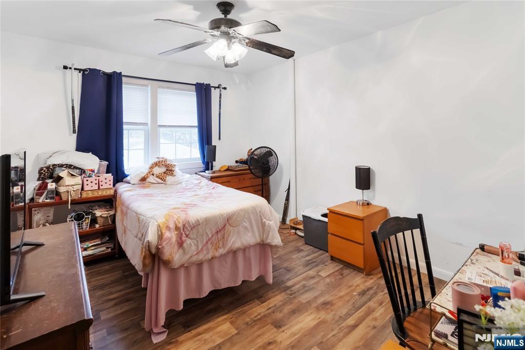 175 Highland Lakes Road Vernon, NJ 07422 - Photo 24 of 50 a bedroom with a bed and wooden floor