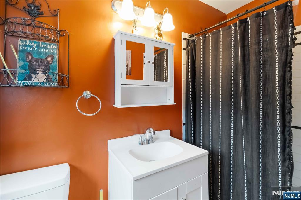 175 Highland Lakes Road Vernon, NJ 07422 - Photo 26 of 50 a bathroom with a sink a mirror and shower