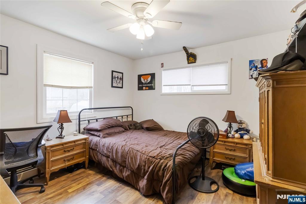 175 Highland Lakes Road Vernon, NJ 07422 - Photo 27 of 50 a bedroom with a bed and a chandelier