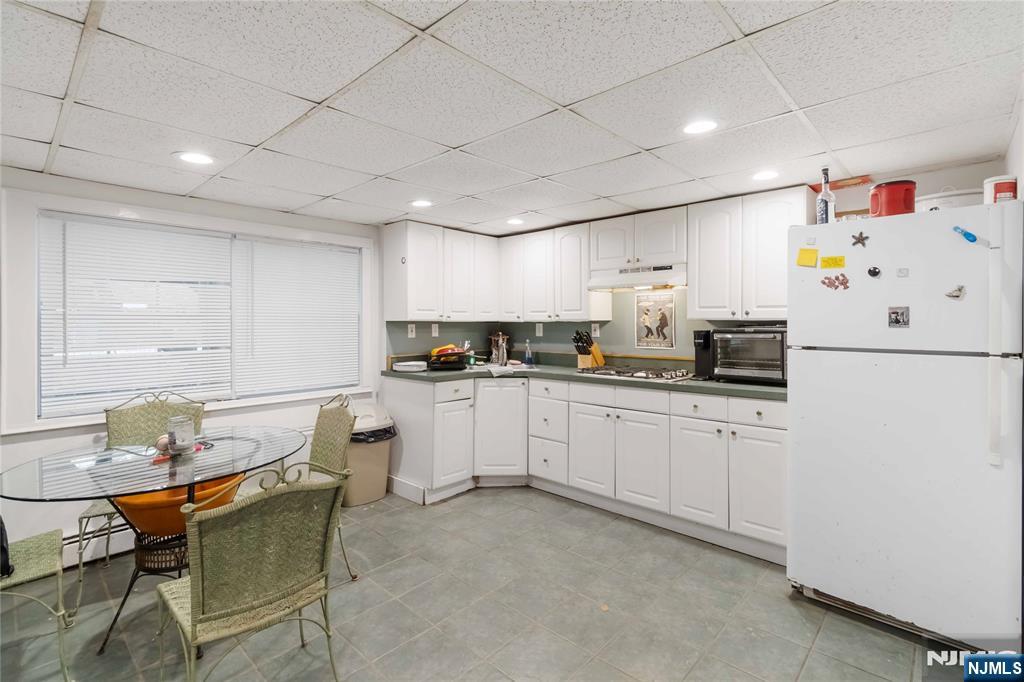 175 Highland Lakes Road Vernon, NJ 07422 - Photo 29 of 50 a kitchen with a refrigerator and white cabinets