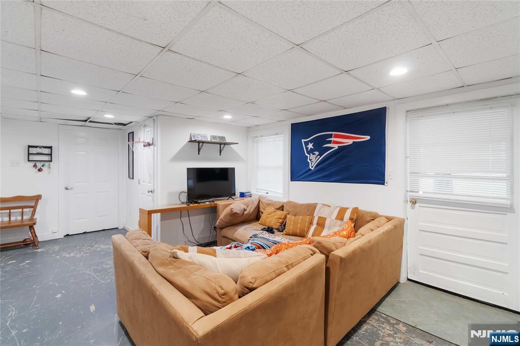 175 Highland Lakes Road Vernon, NJ 07422 - Photo 31 of 50 a living room with furniture and a flat screen tv