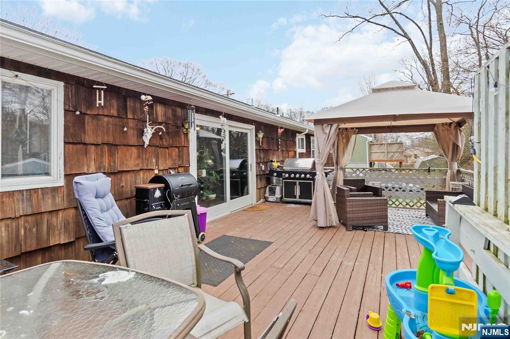 175 Highland Lakes Road Vernon, NJ 07422 - Photo 34 of 50 a living room filled with furniture and floor to ceiling windows