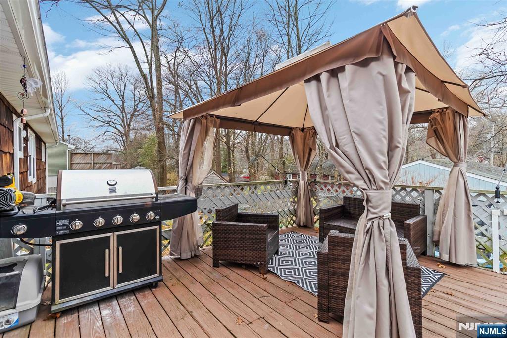 175 Highland Lakes Road Vernon, NJ 07422 - Photo 37 of 50 a view of a chairs and table on the wooden deck