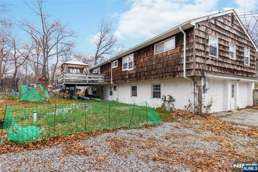 175 Highland Lakes Road Vernon, NJ 07422 - Photo 41 of 50 a front view of a house with a garden