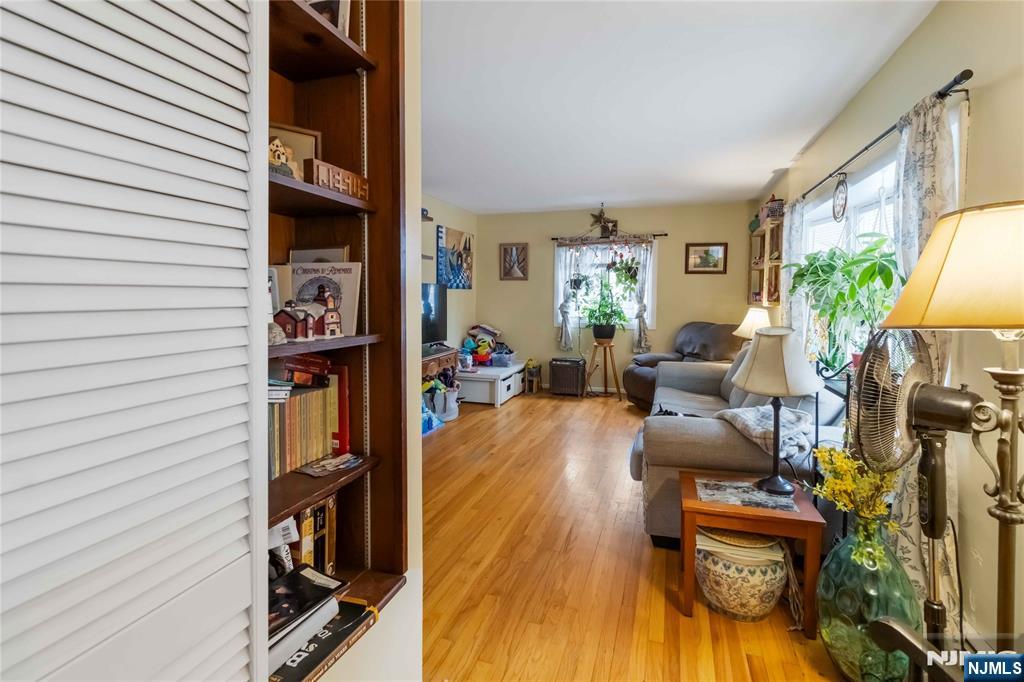 175 Highland Lakes Road Vernon, NJ 07422 - Photo 9 of 50 a living room with furniture and a book shelf