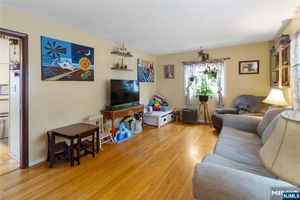 175 Highland Lakes Road Vernon, NJ 07422 - Photo 10 of 50 a living room with furniture and a flat screen tv