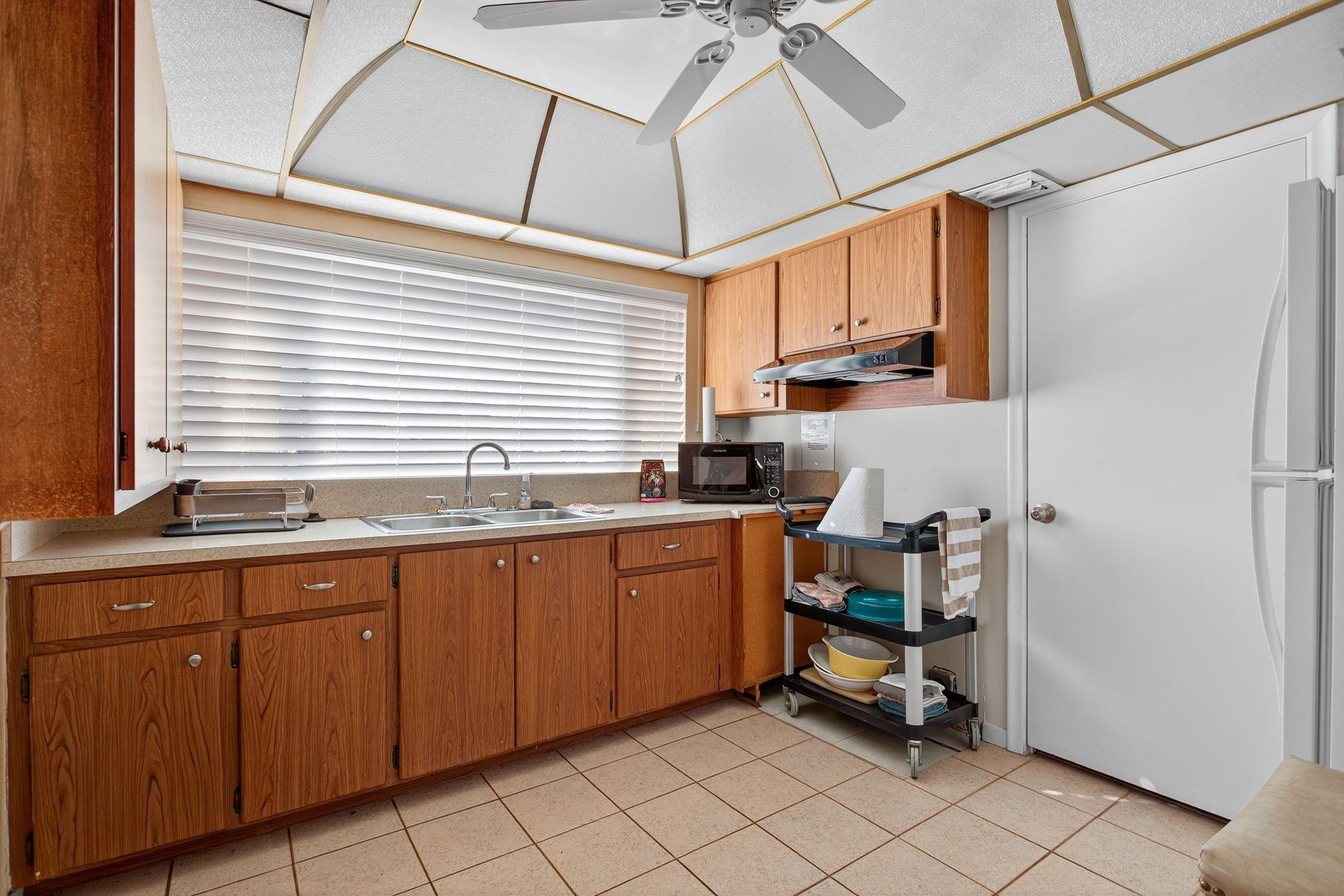 418 South Cypress Road, Unit 110 Pompano Beach, FL 33060 - Photo 24 of 28 a kitchen with sink cabinets and window
