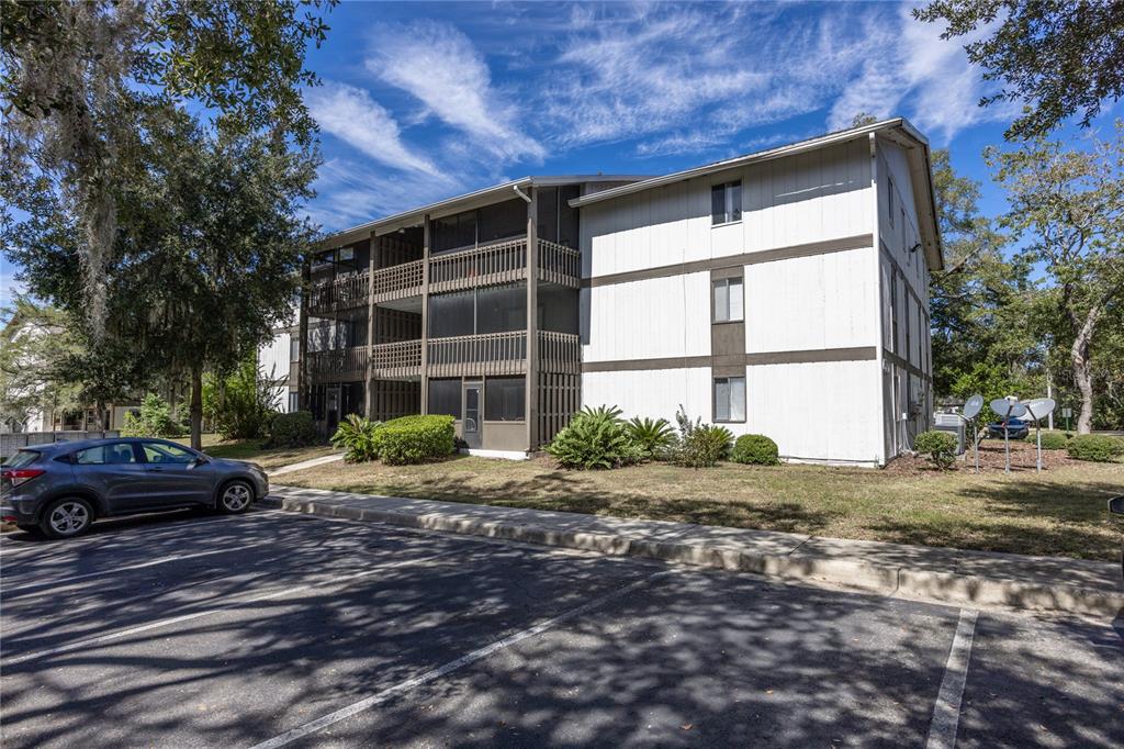 6519 West Newberry Road, Unit 709 Gainesville, FL 32605 - Photo 1 of 1 a front view of a house with a yard
