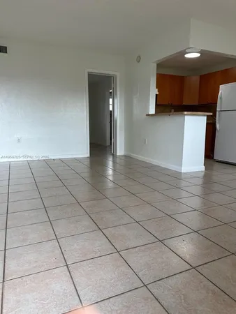 a view of a livingroom with an empty space and a stove top oven