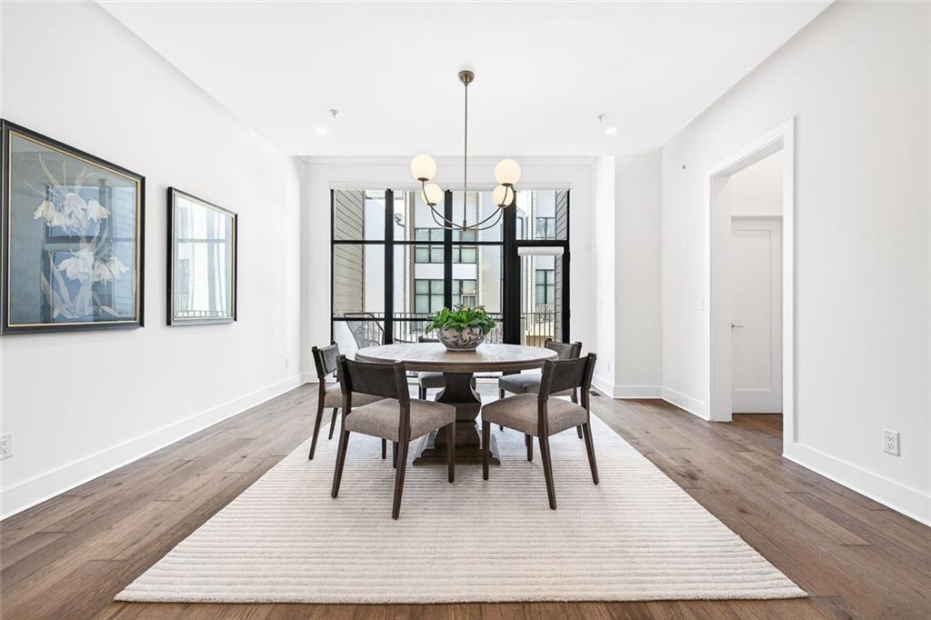 105 Birch Street Decatur, GA 30030 - Photo 13 of 31 a dining room with wooden floor and a floor to ceiling window
