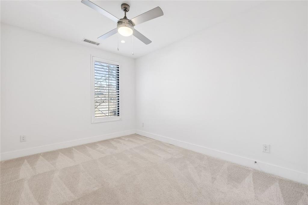 105 Birch Street Decatur, GA 30030 - Photo 21 of 31 an empty room with a window and a fan