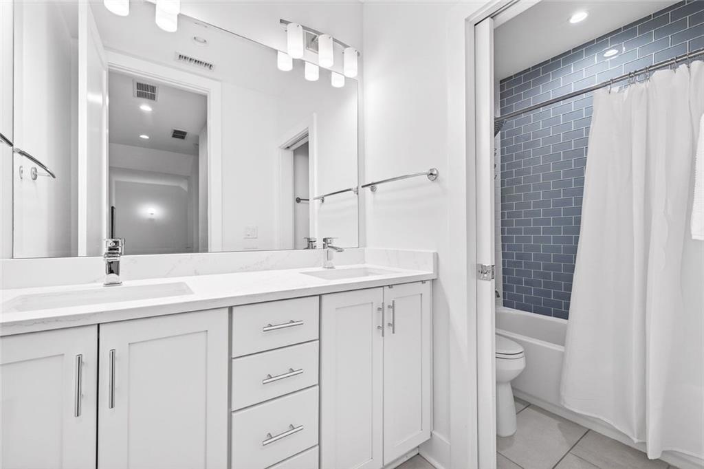 105 Birch Street Decatur, GA 30030 - Photo 22 of 31 a bathroom with a double vanity sink and mirror