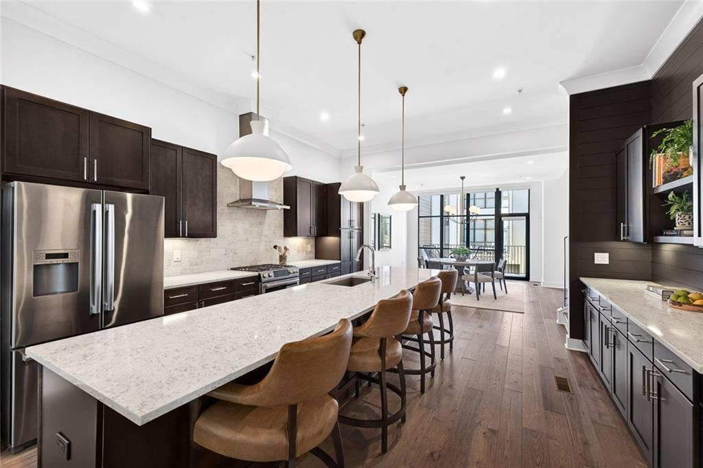 105 Birch Street Decatur, GA 30030 - Photo 6 of 31 a kitchen with stainless steel appliances granite countertop a kitchen island a stove a table and chairs