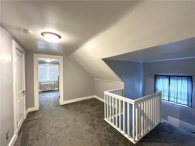 en empty room with windows and stairs