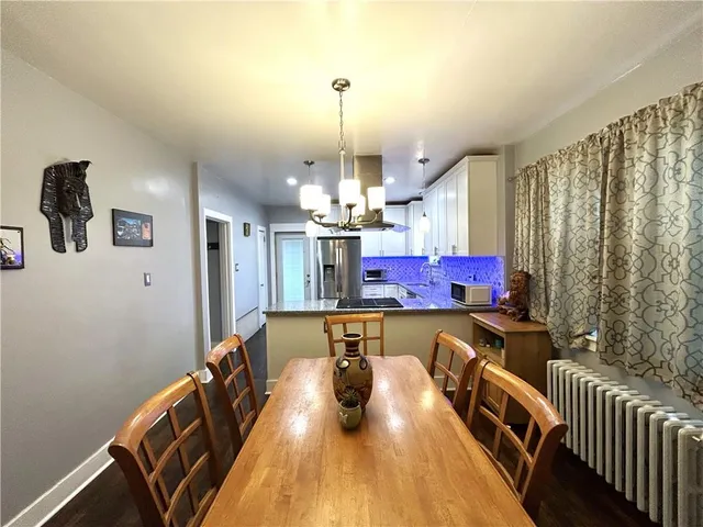 a dining room with furniture and wooden floor