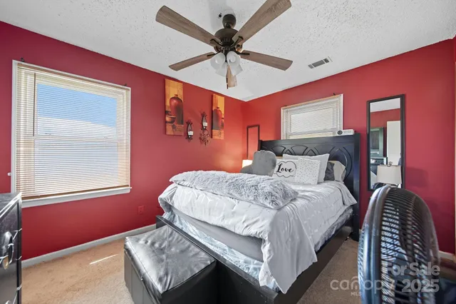 a bedroom with bed and window