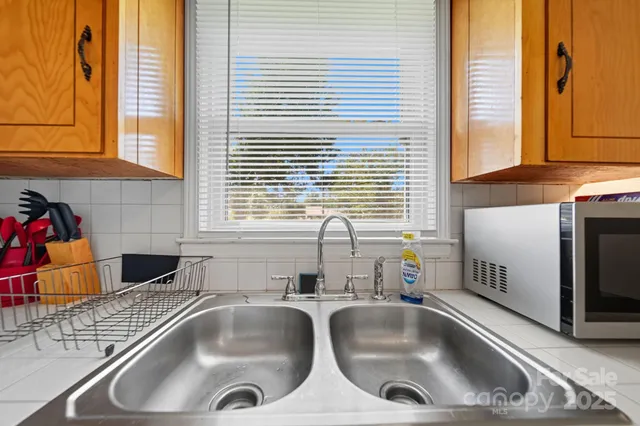 a kitchen with a sink and a large window