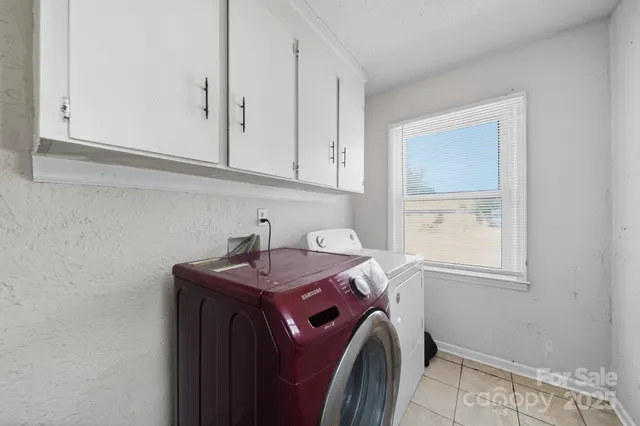 a utility room with cabinetry dryer and washer