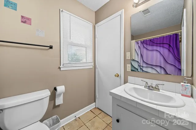 a bathroom with a sink a toilet and a shower
