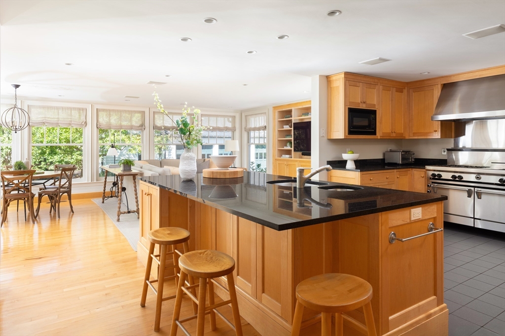 26 Dorset Road Newton, MA 02468 - Photo 7 of 22 a kitchen with stainless steel appliances granite countertop a sink a stove and a refrigerator
