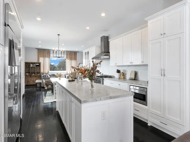 a kitchen with counter top space cabinets and refrigerator