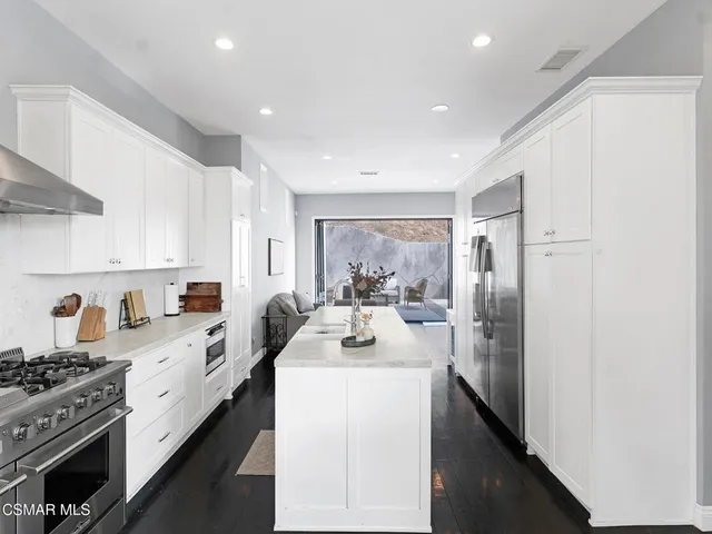 a kitchen with a sink stove and refrigerator