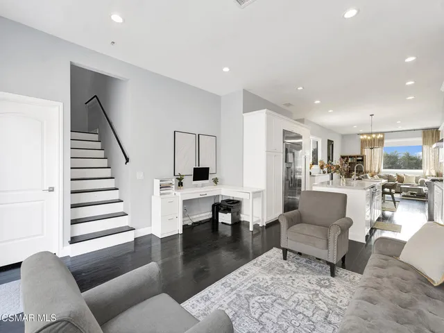 a living room with furniture and a dining table with kitchen view