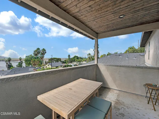 a balcony with table and chairs