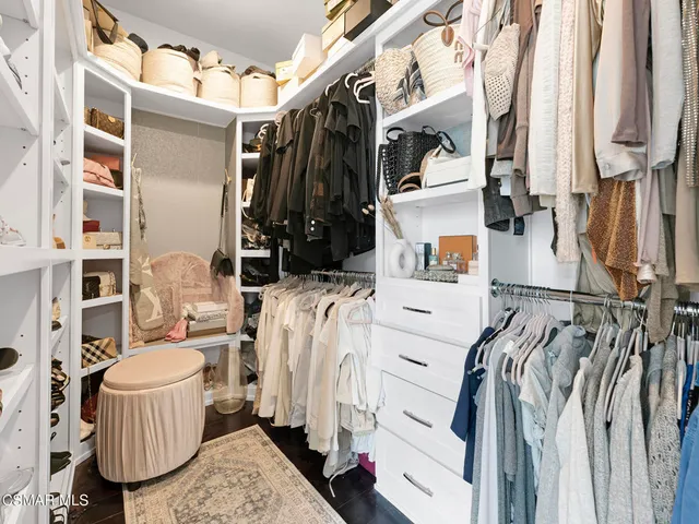 a bathroom with a double vanity sink a toilet a mirror and shower