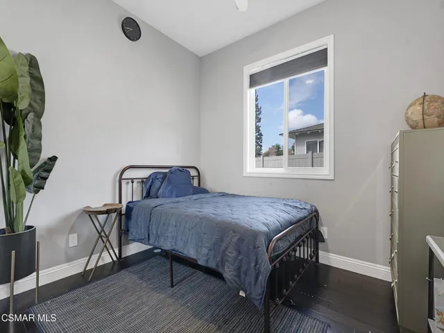 a bedroom with furniture and a potted plant