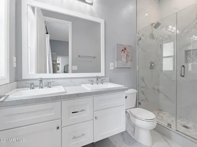 a bathroom with a shower and a toilet