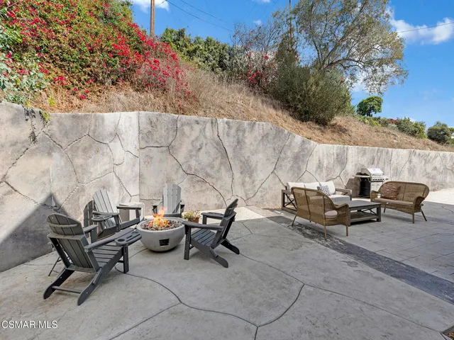 a view of a patio with table and chairs and potted plants