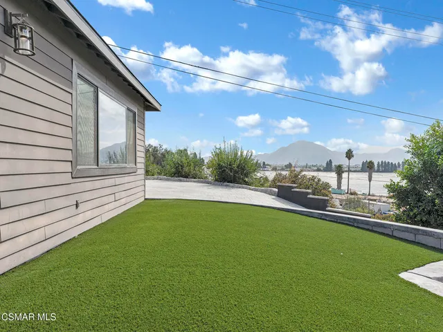 a view of yard with swimming pool and green space