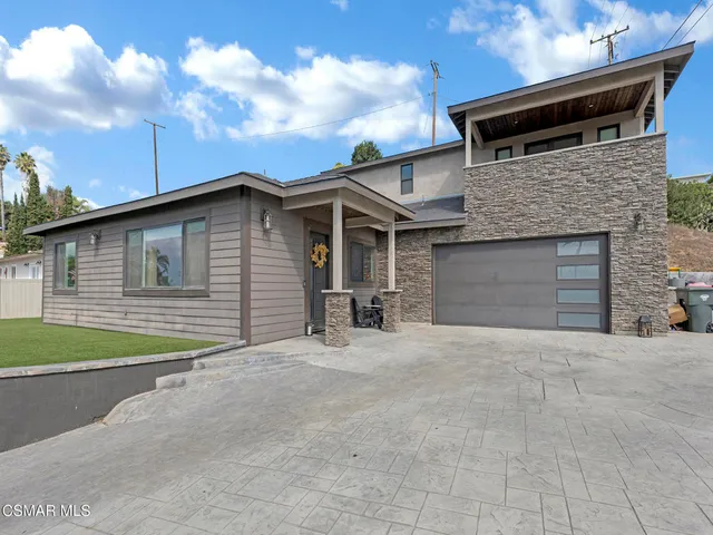 a view of a house with pool and sitting area