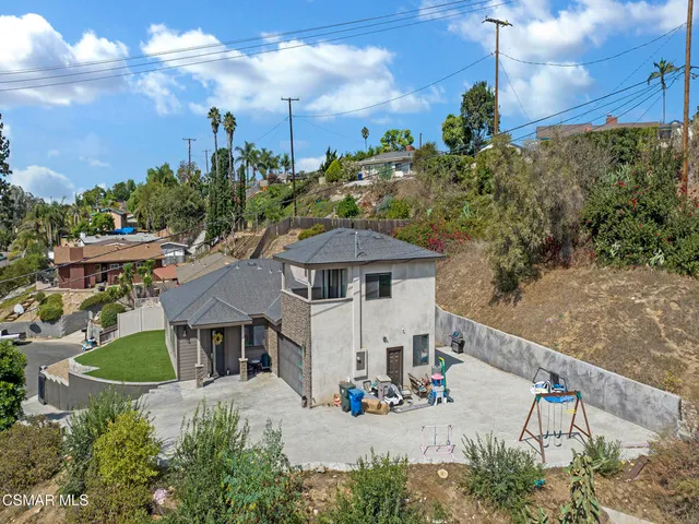an aerial view of a house with a yard