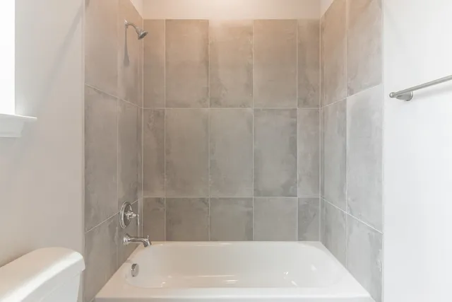 a bathroom with a shower and a bath tub