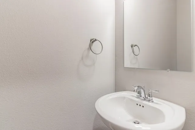a bathroom with a sink and mirror