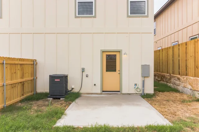 a view of a backyard with wooden fence