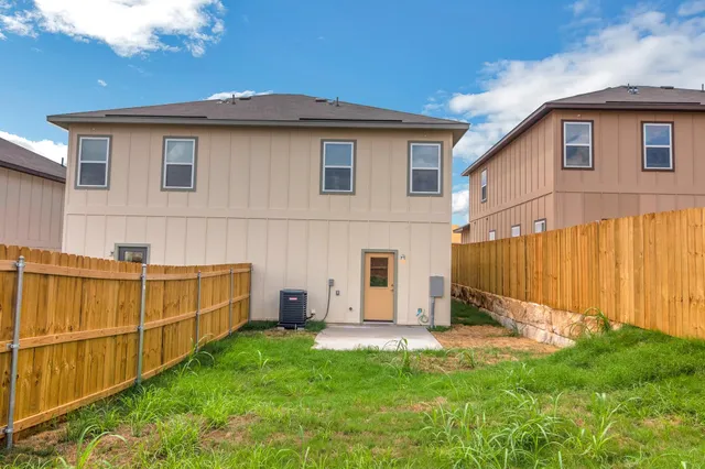 a view of a backyard with wooden fence