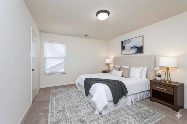 a bedroom with a bed and a window